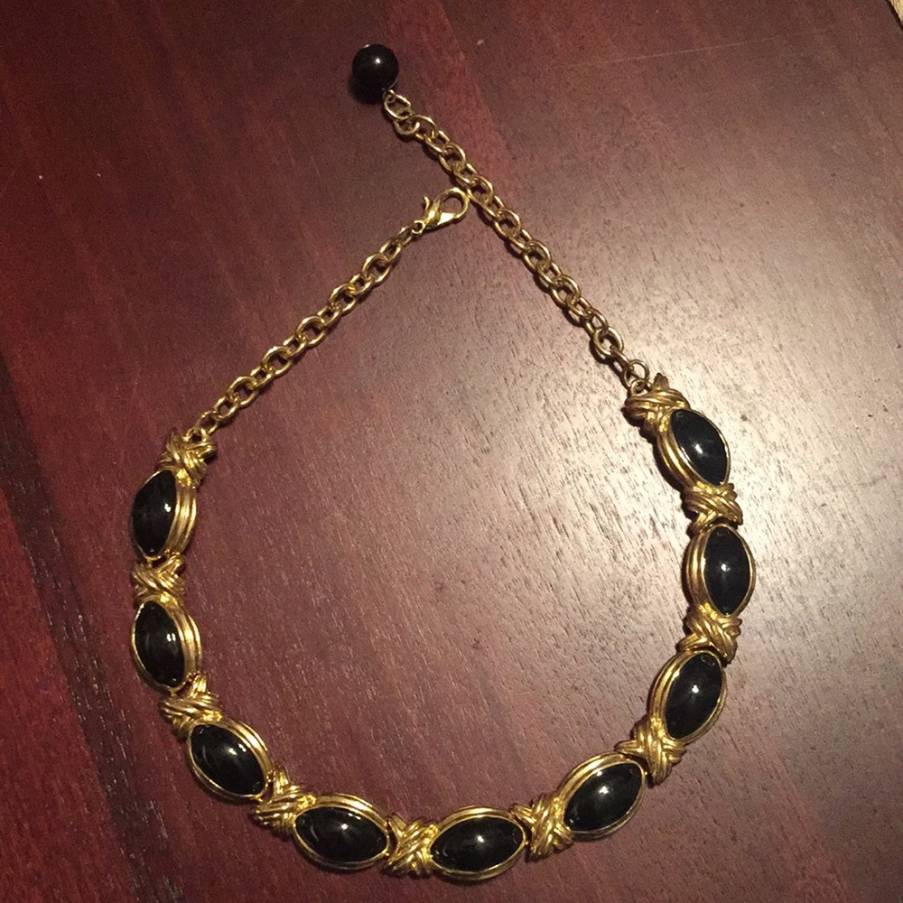 Gold-colored black necklace.